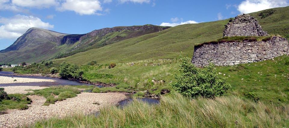 Ben Hope and Pictish Tower ( Broch ) of Dun Dornaigil at trailhead for Ben Hope in Highlands of Northern Scotland